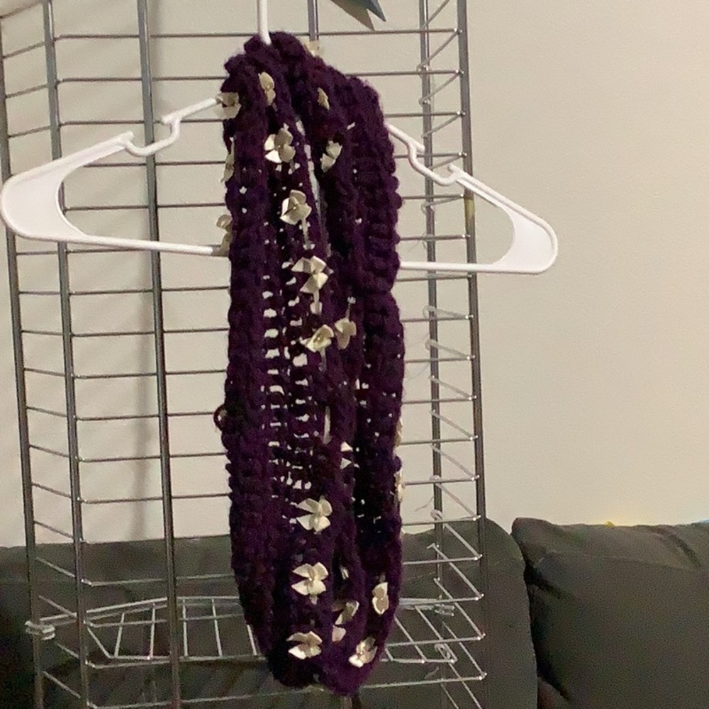 Purple scarf with white bows on it